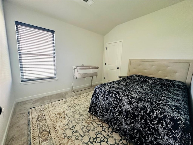 carpeted bedroom featuring lofted ceiling