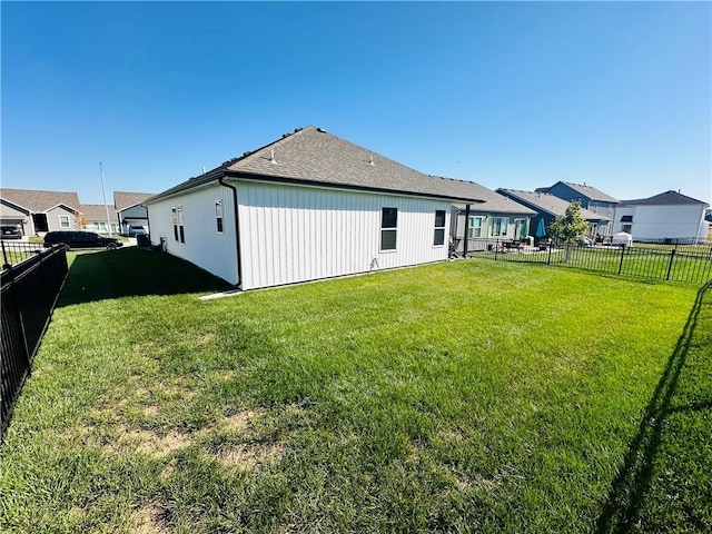 rear view of property featuring a lawn