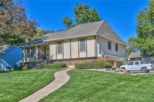 view of front of property with a front yard and a garage