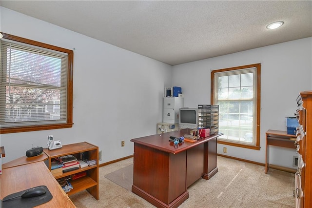 home office with light carpet and a textured ceiling