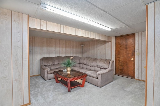 carpeted living room with wooden walls