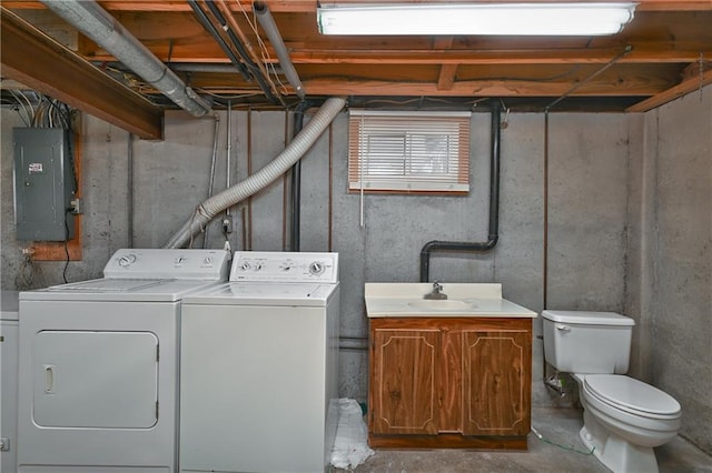 laundry room featuring electric panel, sink, and separate washer and dryer