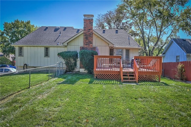 back of property with a deck and a lawn