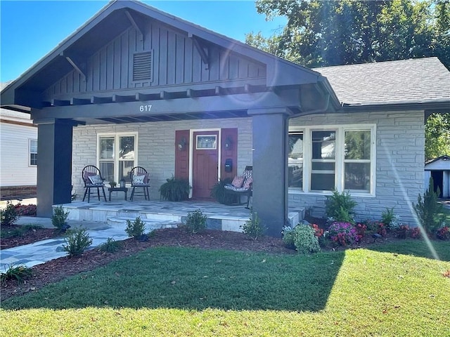 view of front of home with a patio and a front lawn