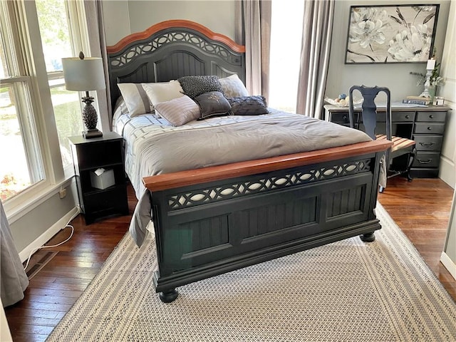 bedroom with dark hardwood / wood-style flooring