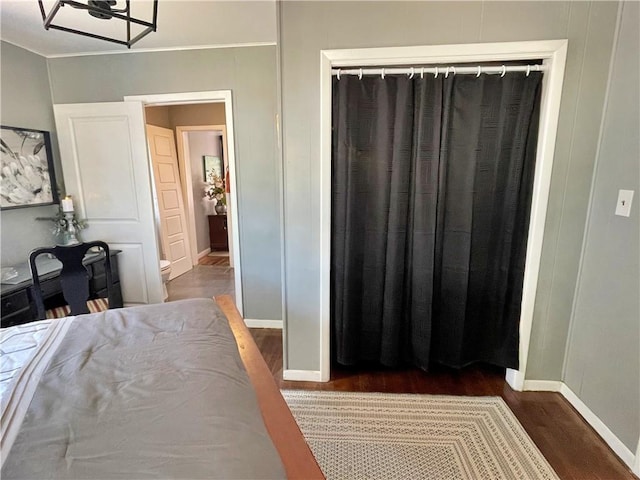 bedroom with a closet and dark hardwood / wood-style floors