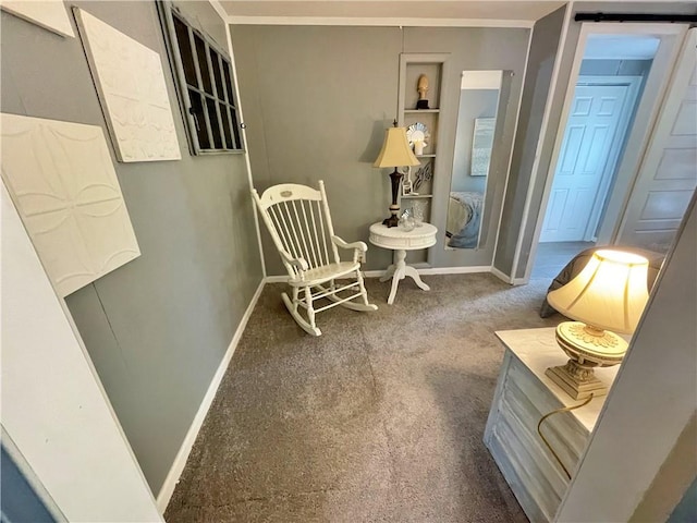 sitting room featuring carpet floors and ornamental molding