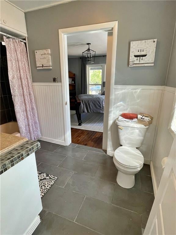 full bathroom with vanity, radiator heating unit, shower / bath combo, hardwood / wood-style flooring, and toilet