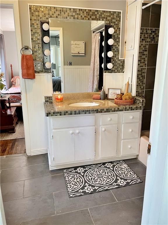 bathroom featuring a shower with shower curtain, hardwood / wood-style flooring, and vanity