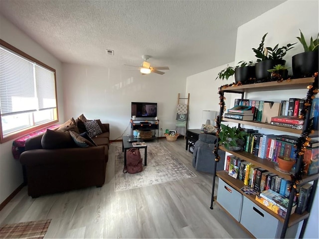 111 W 9th St, Maryville, MO 64468 - living room with light wood-type flooring, ceiling fan, and a textured ceiling