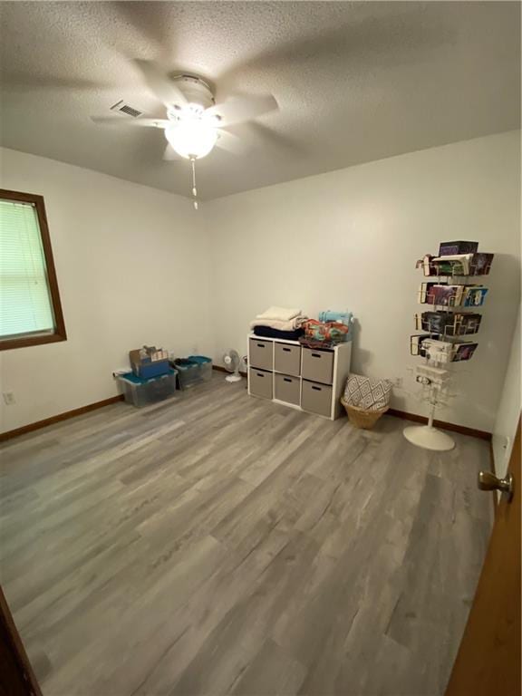 111 W 9th St, Maryville, MO 64468 - misc room featuring wood-type flooring, a textured ceiling, and ceiling fan