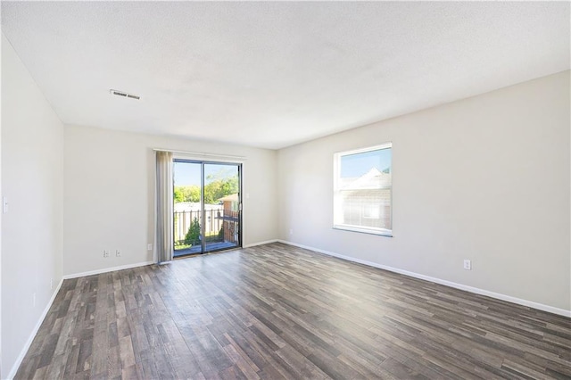 spare room with dark hardwood / wood-style floors