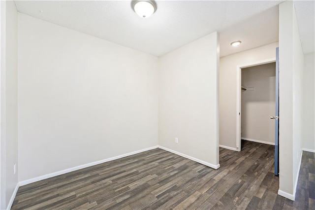 spare room with dark hardwood / wood-style flooring