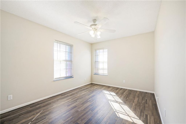 spare room with ceiling fan and dark hardwood / wood-style flooring