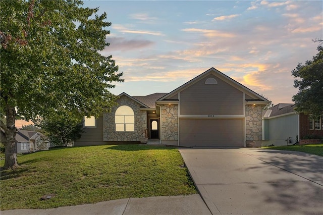 single story home with a yard and a garage