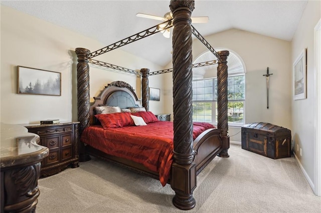 bedroom with light colored carpet, vaulted ceiling, and ceiling fan