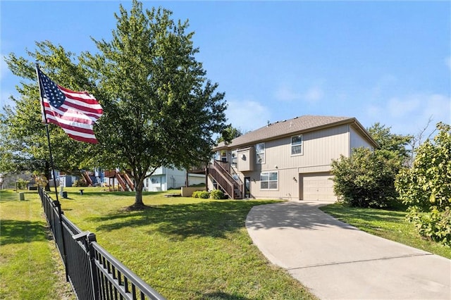 view of front of property featuring a front yard and a garage