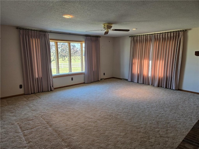 spare room with ceiling fan, a textured ceiling, and carpet flooring