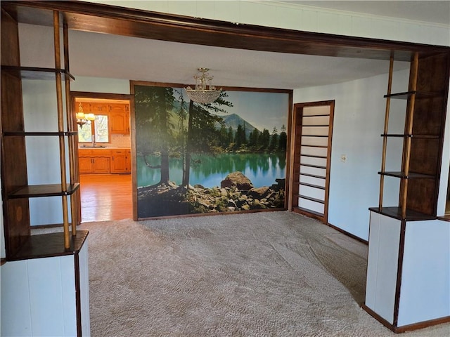 spare room featuring carpet flooring and crown molding