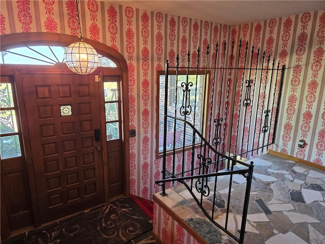 entryway featuring an inviting chandelier and a healthy amount of sunlight