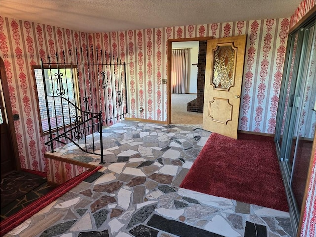 foyer featuring a textured ceiling