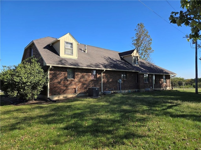 rear view of house featuring a yard