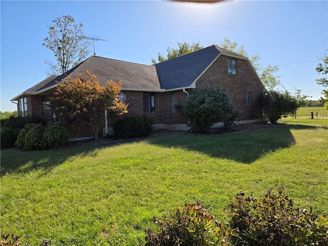 view of side of property with a lawn