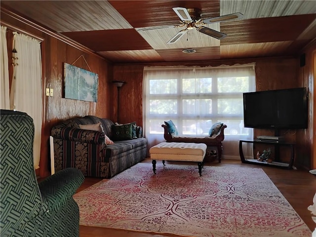 living room with wood walls, wooden ceiling, hardwood / wood-style floors, and ceiling fan