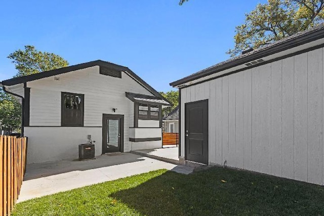 rear view of property with central AC unit and a patio area