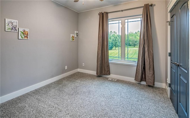 carpeted empty room with ceiling fan