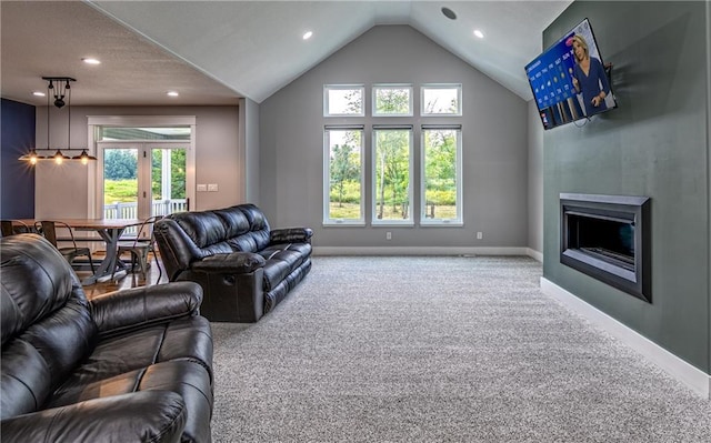 carpeted living room featuring french doors, vaulted ceiling, and a wealth of natural light