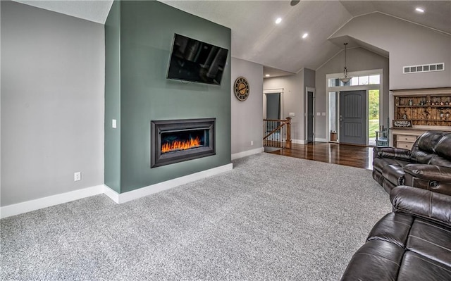 living room featuring carpet floors and lofted ceiling