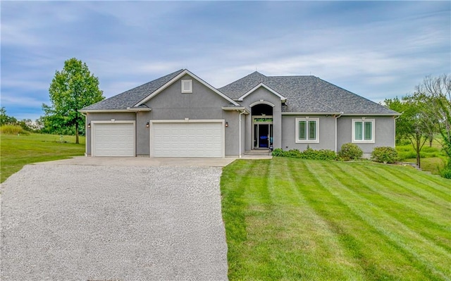 view of front of home with a front lawn and a garage