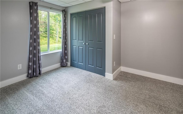 unfurnished bedroom featuring a closet and carpet flooring