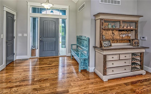 foyer featuring bar area and hardwood / wood-style floors