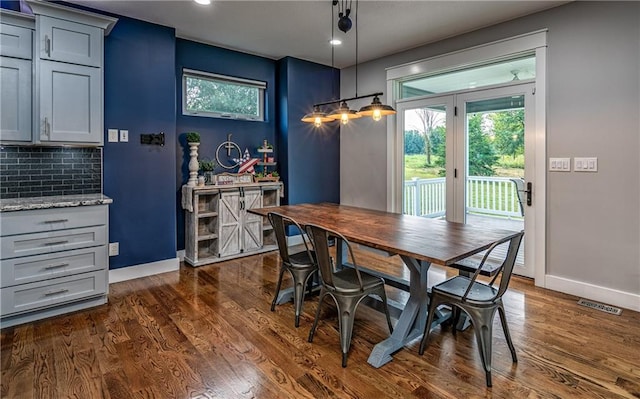 dining area with dark hardwood / wood-style flooring