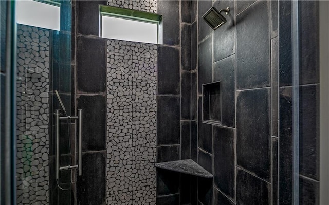 bathroom with a tile shower