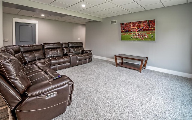 living room with carpet flooring and a paneled ceiling