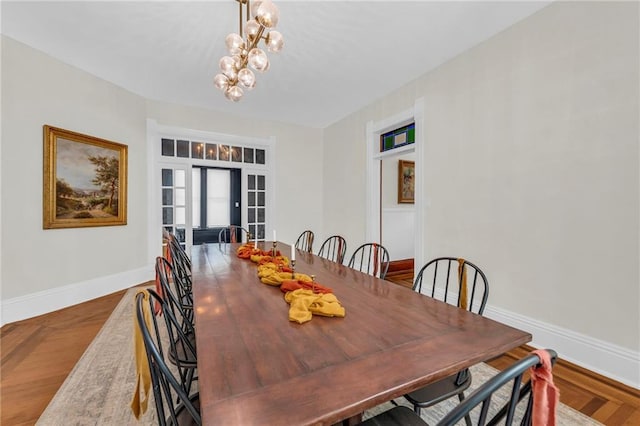 dining room with hardwood / wood-style flooring and a notable chandelier