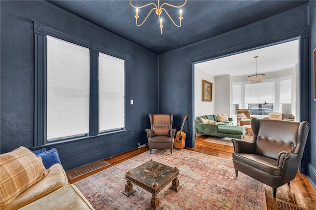 living room featuring a chandelier and hardwood / wood-style flooring