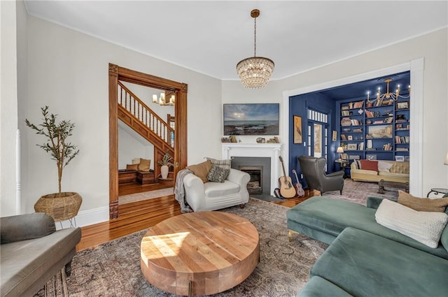 living room featuring an inviting chandelier and wood-type flooring