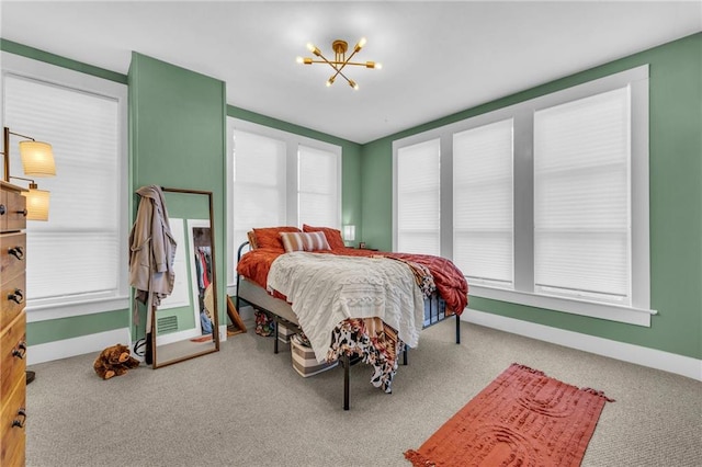 bedroom with a chandelier and carpet