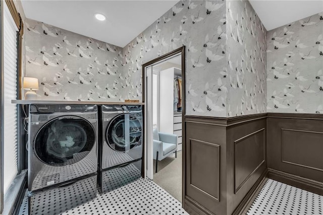 clothes washing area with washing machine and dryer