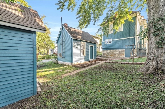 view of side of home with a lawn