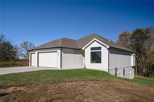 ranch-style home featuring a garage, concrete driveway, roof with shingles, and a front yard