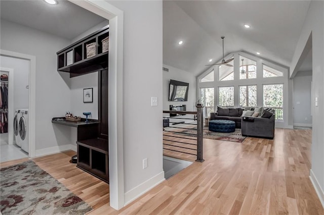 hallway with recessed lighting, an upstairs landing, wood finished floors, washer and dryer, and baseboards