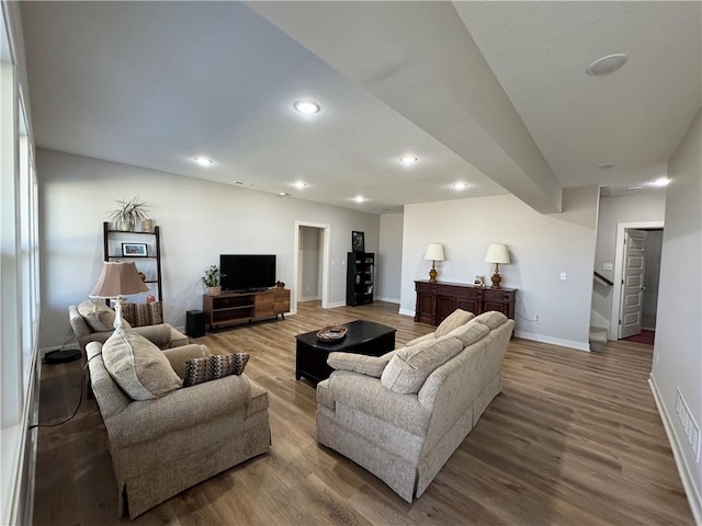 living area featuring recessed lighting, stairway, baseboards, and wood finished floors