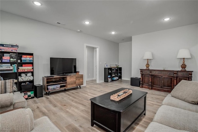 living area with recessed lighting, baseboards, visible vents, and light wood finished floors