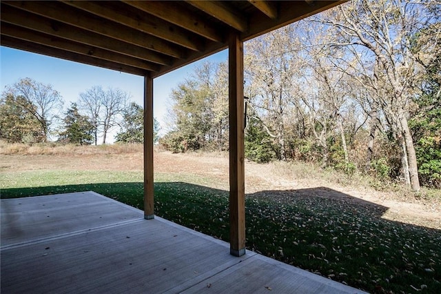 wooden terrace featuring a lawn