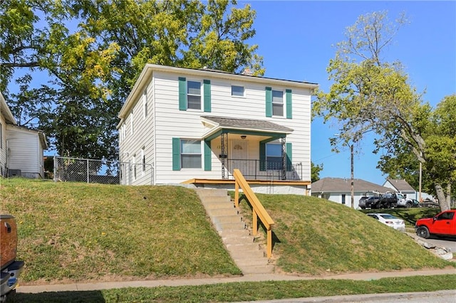 view of front facade with a front lawn and covered porch